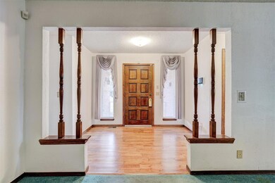Entrance foyer featuring a textured ceiling and li