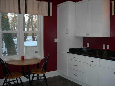 Kitchen. White cabinetry and black granite counter