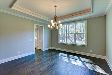The formal dining room includes tray ceilings with