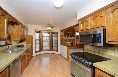 Tons of cabinets pace in this fantastic kitchen.