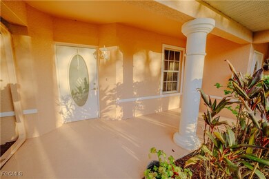 Doorway to property featuring stucco siding and a porch