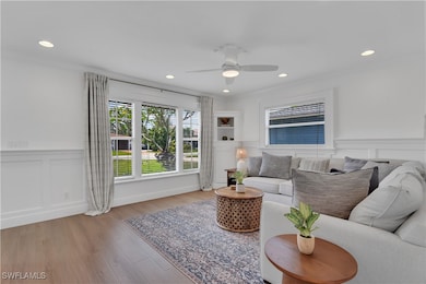 Living area featuring crown molding, recessed ligh