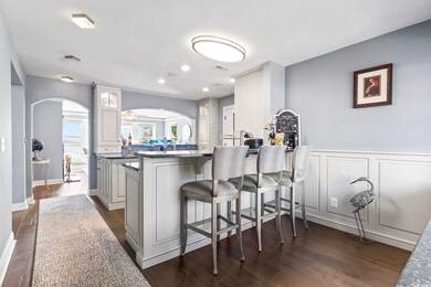 Kitchen with dark wood-type flooring, white cabine