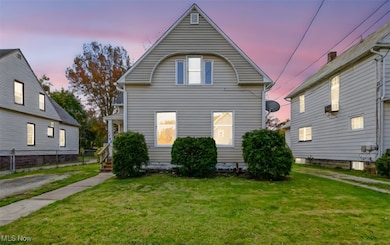 View of back of property at dusk