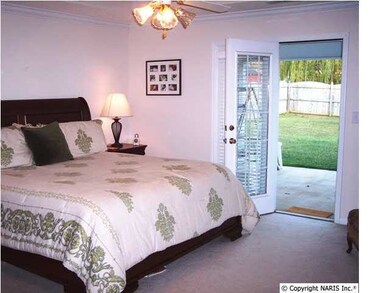 The isolated master bedroom is large enough for a king size bed and several pieces of large furniture. The french doors lead to the covered patio where you can put up a swing, enjoy a morning cup of coffee and watch the kids play!