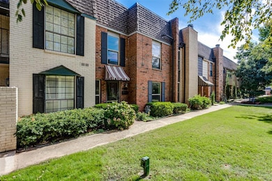 View of property exterior featuring brick siding, a lawn, a shingled roof, and mansard roof