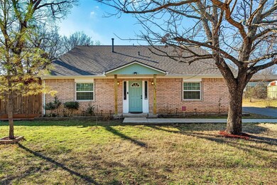 Ranch-style home with brick siding, a shingled roo