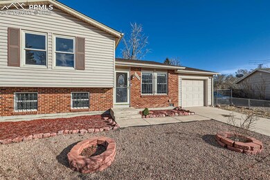 Split level home with an attached garage, fence, d