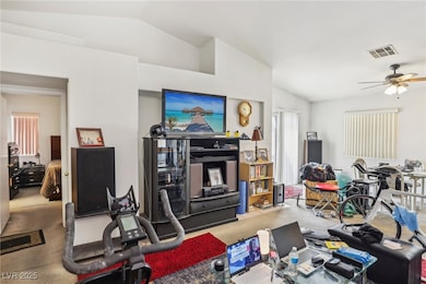 Living room featuring visible vents and lofted cei