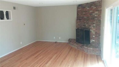 Refurbished hardwood flooring, used brick fireplac