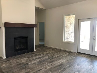 Unfurnished living room featuring a tile fireplace