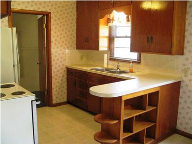 Kitchen - range and refrigerator remain.