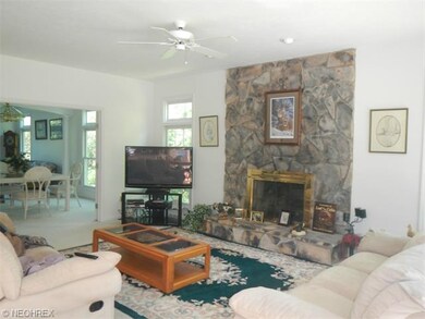 Family room floor to ceiling stone fireplace.