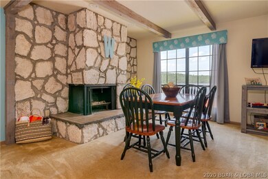 Wood fireplace is a focal point of the open living