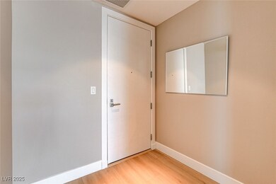 Entryway featuring baseboards, light wood-style fl