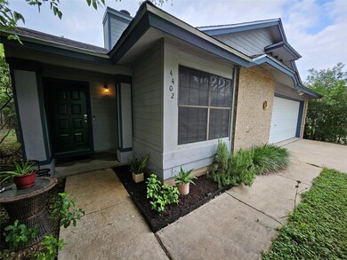 Doorway to property with concrete driveway and a 