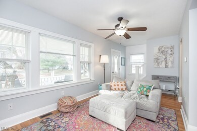 Living room with ceiling fan and wood-type flooring