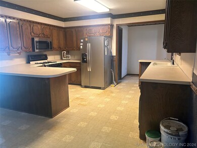 Kitchen opens to back sunroom