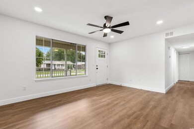 Spare room with wood-type flooring and ceiling fan