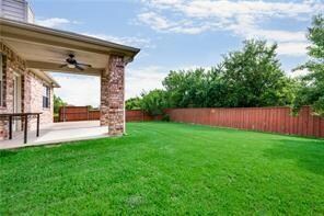 View of yard with a patio area and ceiling fan