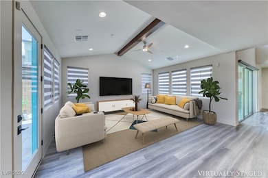 Living area with wood finished floors, ceiling fan