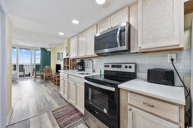 Kitchen with stainless steel appliances, light bro