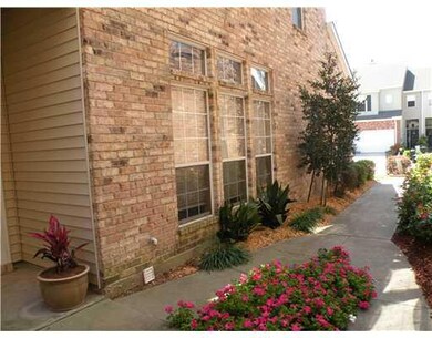 Facade/Exterior Front. Cheery landscaped walkway t