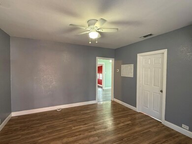 Empty room with ceiling fan and dark hardwood / wo