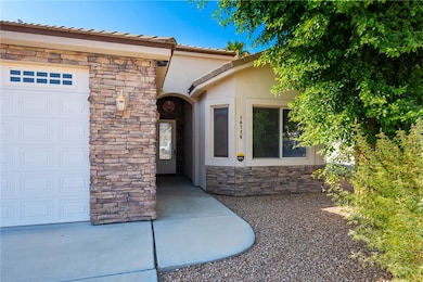 Doorway to property with stone siding, stucco sidi