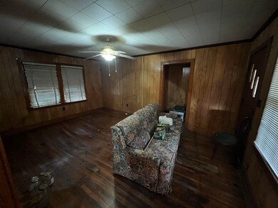Interior space featuring ceiling fan, dark wood-ty