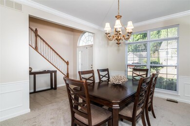 Dining room with crown moulding.