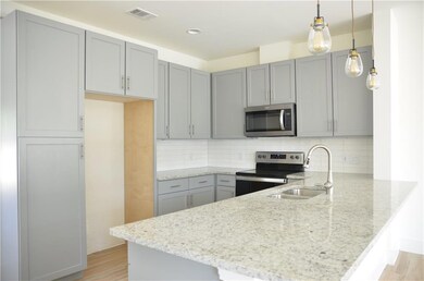 Kitchen featuring stainless steel appliances, a p