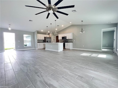 Unfurnished living room with ceiling fan with nota