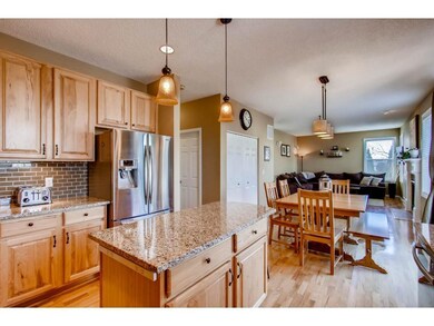 Hardwood floors flow to the back foyer area off th