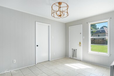 Unfurnished room featuring an inviting chandelier,