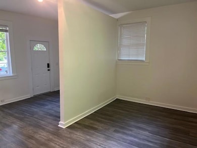 Entryway featuring dark wood-style flooring and ba