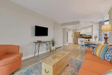 Living room featuring light wood-style flooring an