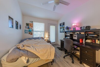 Bedroom featuring light wood-style floors, vaulte