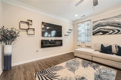Living area with ornamental molding, baseboards, w