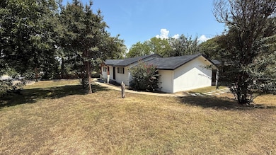 View of property exterior featuring a lawn