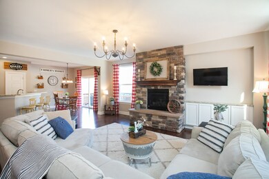 Alternate view of living room towards kitchen, eat-in area, and door leading to deck/pool