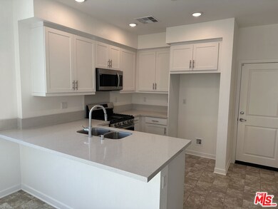 Kitchen with white shaker-style cabinets and upgra