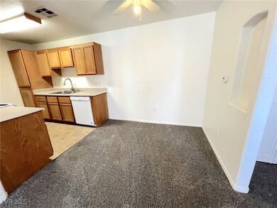 Kitchen featuring a sink, ceiling fan, visible ven
