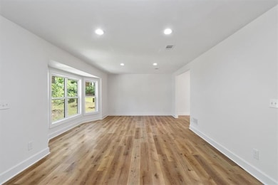 Spare room with recessed lighting and light wood-style flooring