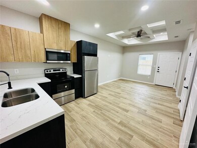 Kitchen with a ceiling fan, visible vents, a skylight, a sink, and stainless steel appliances