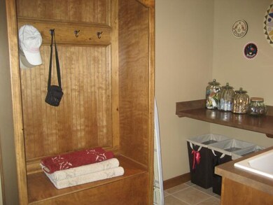 Mud bench located in tiled Main floor Laundry Room