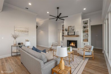 Living room featuring crown molding, ceiling fan, 