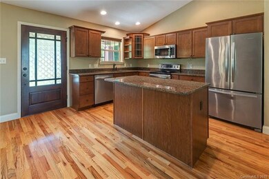 Shiny clean kitchen with granite counter tops and 