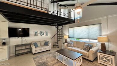 Living area featuring a high ceiling and stairway
