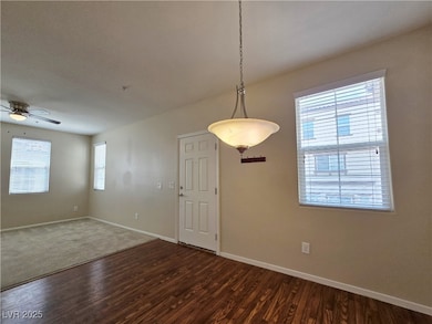 Unfurnished room with baseboards, dark wood finish